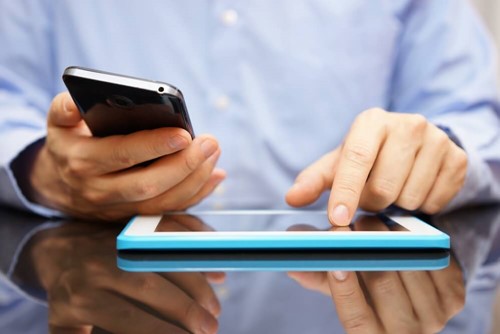 an employee working on a phone and tablet