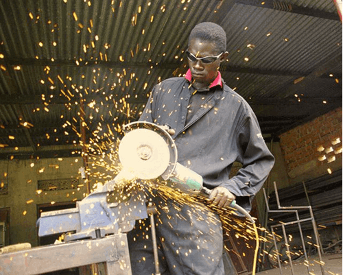 A man using a saw at work.