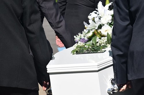 mourners carrying a coffin