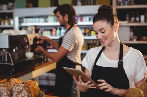 cafe worker using a computer tablet