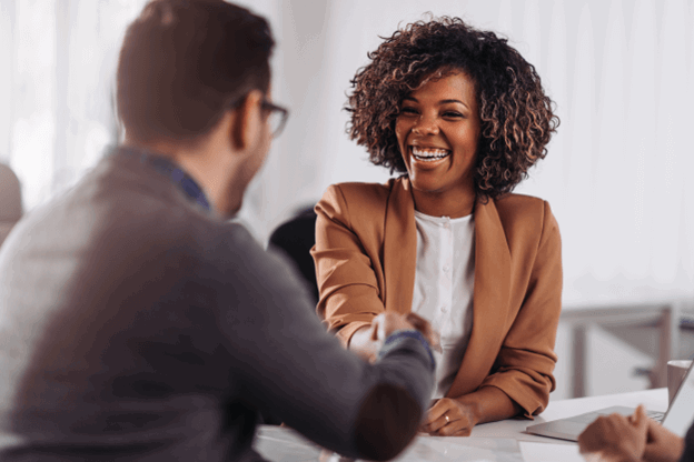 A male and a female employee shaking hands