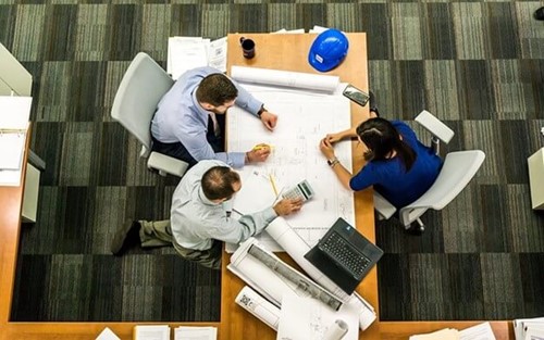 three people discussing building plans