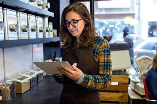 a retail worker using a tablet
